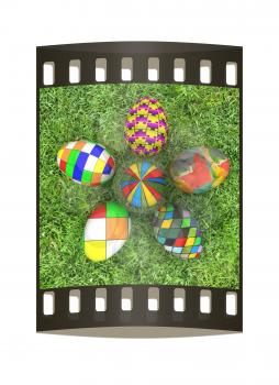 Flower of Easter eggs on the grass. The film strip with place for your text