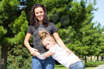 Photo of smiling mother and daughter in summer
