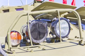 Headlight of military machine at the exhibition under open sky
