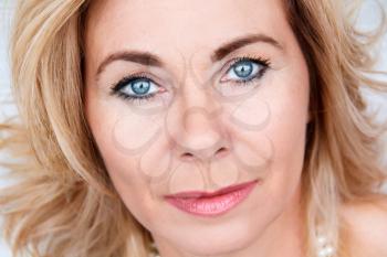 Horizontal portrait of adult blond woman with makeup