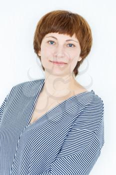 Portrait of happy woman with short brown hair near white wall