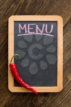 Chalk board menu and red chili pepper