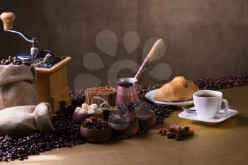 Still-life with coffee, cup with saucer, coffee beans and spices.