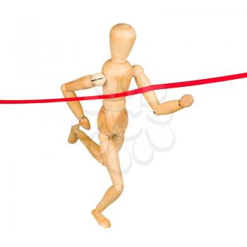 Wooden mannequin running through finishing line. Isolated on white.