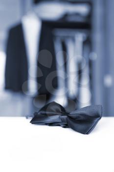 Bow tie. Open closet and tuxedo. Getting ready for formal night. With isolated place for text.