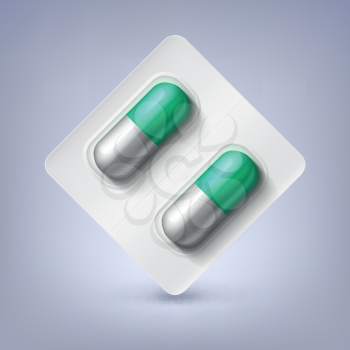 Green and white capsules, pill in a blister pack