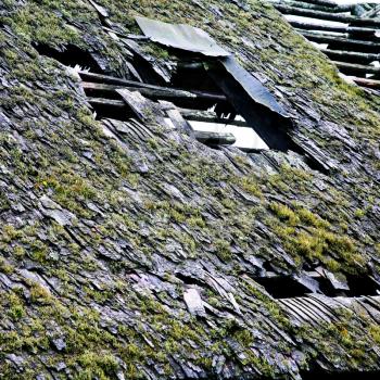 old broken shingle roof of neglected country house