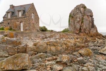 country Breton house made from rock on Pink Granite Coast in Brittany, in France