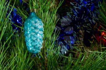 blue glass cone and tinsel on Christmas-tree