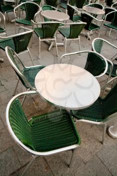 round metal table in empty street cafe