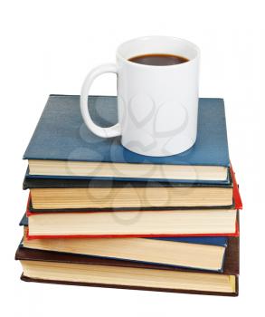 white cup of coffee on stack of books isolated on white background