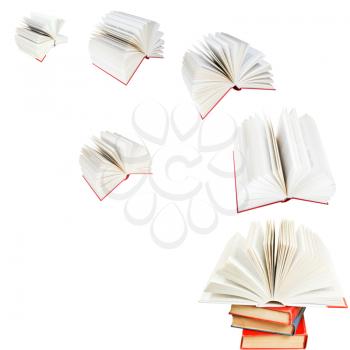 open books fly out of pile of books isolated on white background