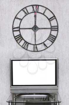 mitnight time on wall clock under blank white screen of TV set