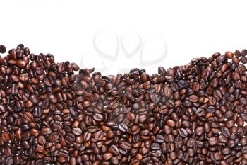hills from roasted coffee beans close up on white background