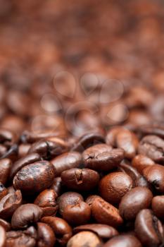 background from dark roasted coffee beans with focus foreground