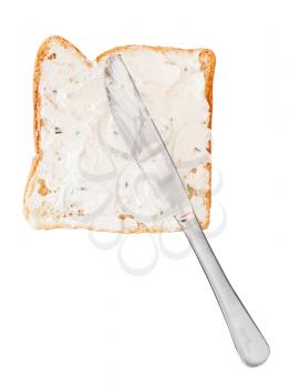 sandwich from toast and soft cheese with herbs, table knife isolated on white background