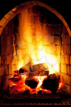 flames of fire in fireplace in evening time
