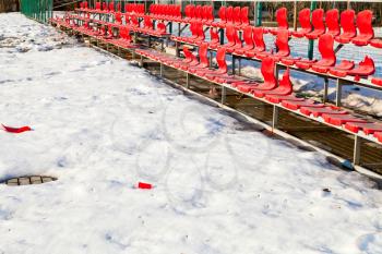 red broken plastic seats at sport ground in low season