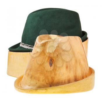 linden wooden hat block and green tyrolean felt hat isolated on white background