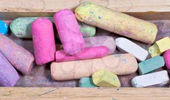 colored chalks in wooden box close up