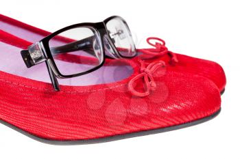 red woman shoes and black no name eyeglasses isolated on white background