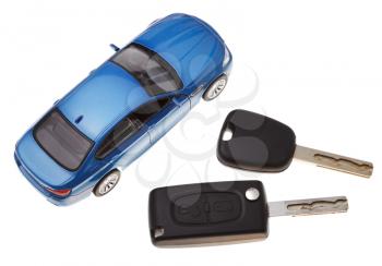 top view of two vehicle keys and model car isolated on white background