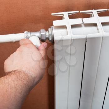 adjustment of thermostat of heating radiator