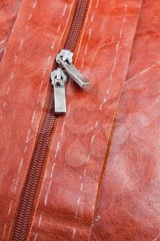metal runners of zipper on cutting leather clothing
