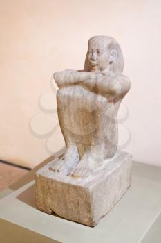 antique stone Egyptian statue of sitting man