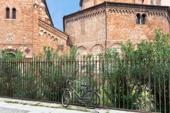 bicycle near fence of ancient Santo Stefano Abbey in Bologna, Italy