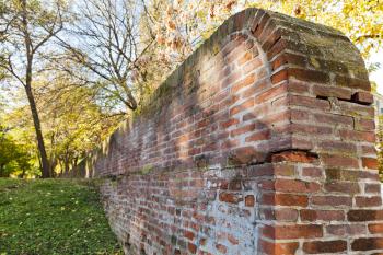 old brick medieval wall of the ex papal fortress in Ferrara, Italy