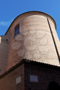 medieval tower and stone street signs in Ferrara, Italy