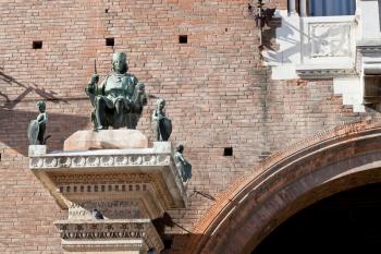 statue on wall of ancient City Hall in Ferrara, Italy