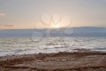 pebble beach of Dead sea in Jordan on sunset