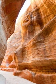 multicoloured sandstone walls of gorge Siq in Petra, Jordan