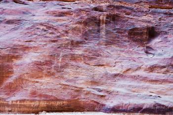 multicolored sandstone wall of gorge Siq in Petra, Jordan