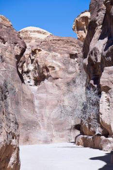 sand rock cliffs above gorge Siq in Petra, Jordan
