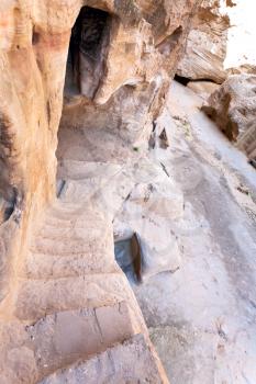 steep ancient stone steps to antique living chamber in Little Petra, Jordan
