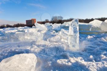 house and blocks of clear river ice in cold winter day in Moscow, Russia
