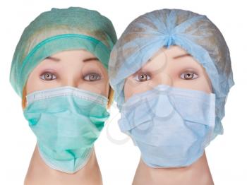 female dummy doctor heads wearing textile surgical cap and medical protective mask isolated on white background