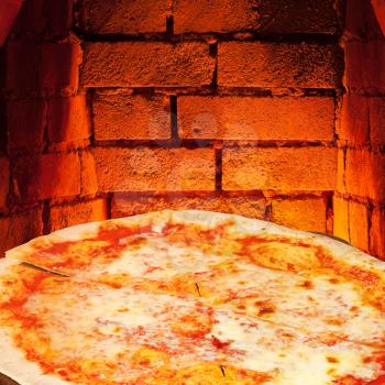 italian pizza margherita and hot brick wall of wood burning oven
