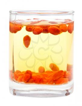 preparing of goji berry tincture - side view glass with goji berries infusion isolated on white background