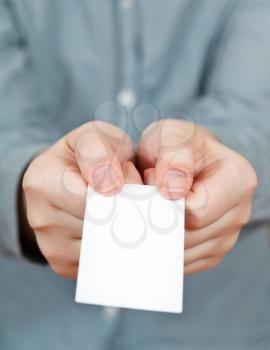 blank business card in female hands close up