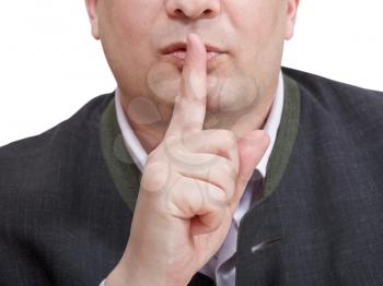 businessman's finger near lips - silence hand gesture isolated on white background