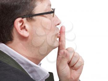 side view of businessman's finger near lips - silence hand gesture isolated on white background
