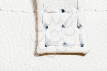 thread stitch on white leather close up