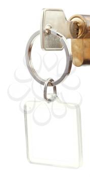 door key with cut out square keychain in cylinder lock close up isolated on white background