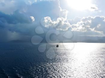 ship comes to Calabria shore in Strait of Messina in summer evening