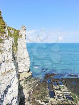 view of old oyster farm and cliff on english channel beach of Etretat cote d'albatre, France
