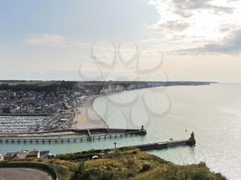 above view of English Channel coast and Etretat town in Normandy, France